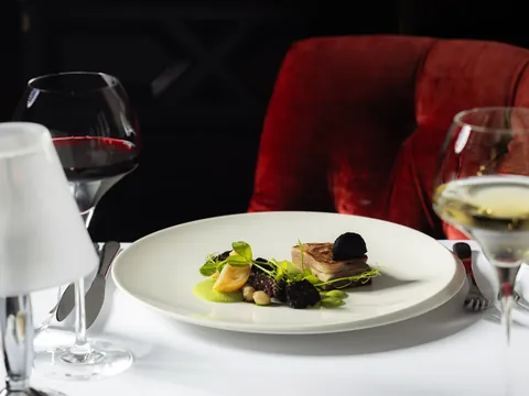 Starter plate in the dining room, with red velvet banquette seating