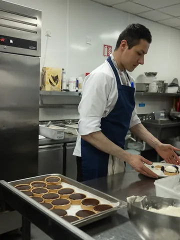 A chef preparing chocolate tarts in the kitchen
